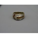 9CT GOLD ART DECO BUCKLE FORM RING with rubies and diamonds, 5.7grms