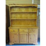 MODERN PINE DRESSER with two shelf rack over a base arrangement of three drawers and three