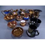 COPPER LUSTRE - approximately 6 jugs, 3 basins and a mug and a black lustre cream jug and sugar