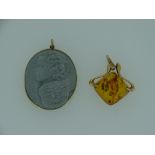 TWO NECKLACE PENDANTS, 14ct Russian gold and amber and a carved stone cameo type of a winged