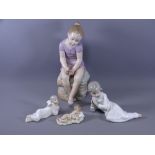 NAO/LLADRO FIGURINES, three recumbent figures of children and a larger NAO seated figurine of a