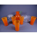 ORANGE GLASS SIX PIECE LEMONADE/WATER SET, the jug having a green handle, a cut glass fruit bowl and