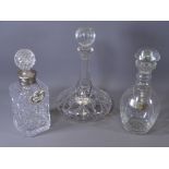 THREE GLASS DRINKS DECANTERS with stoppers and labels