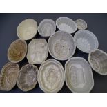 19TH CENTURY & LATER POTTERY JELLY MOULDS, 13 various with impressions of fruit and flowers ETC
