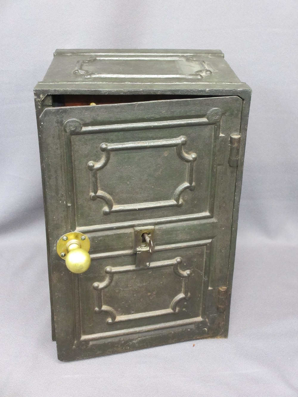 VINTAGE CAST IRON SAFE with key, the door opening to reveal nine interior mahogany drawers with bone