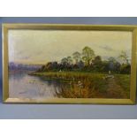 HENRY K FOSTER oil on canvas - lakeside village scene with a figure tending geese, 44 x 79.5cms