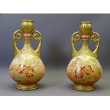 LIMOGES - a pair of floral decorated twin-handled narrow neck vases, 26cms H