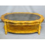 REPRODUCTION WALNUT EFFECT COFFEE TABLE having a shaped top with glass insert, on segmented and