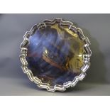 CIRCULAR SILVER TRAY, uninscribed with wavy border and four scrolled supports, 42cms diameter, 55