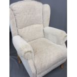 A MODERN WINGBACK ARMCHAIR, beige in colour