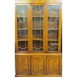A REPRODUCTION BOOKCASE CUPBOARD with triple astragal glazed doors above three panelled cupboard
