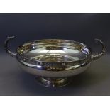 PEDESTAL CIRCULAR SILVER BOWL decorated in the Celtic style and with curved serpent handles, 25 troy