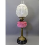 VICTORIAN OIL LAMP with pink moulded glass font and relief moulded globular shade, 66cms overall H
