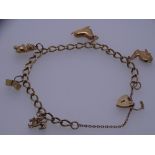 A 9CT GOLD FIVE CHARM BRACELET with padlock and chain, 13grms