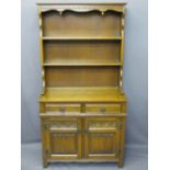 REPRODUCTION OAK NEATLY PROPORTIONED DRESSER with linen fold and other carved detail, 176cms H, 52.