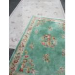 TWO CONTINENTAL WOOLLEN RUGS including a Chinese washed woollen example, green ground with single