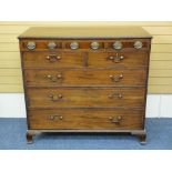 REGENCY MAHOGANY CHEST OF DRAWERS having three slim upper drawers with fancy oval brass plate