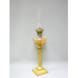 VICTORIAN OIL LAMP with clear glass facet cut font on a Corinthian column brass base, 79cms