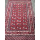 PERSIAN TYPE WOOLLEN RUG, red ground with a block pattern repeat centre and multi-bordered edge, 195