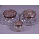 THREE SILVER TOP CUT GLASS DRESSING TABLE JARS, Birmingham hallmarks for 1902, 1963 and 1966, the