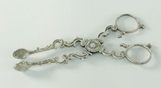 BELIEVED 18TH CENTURY IRISH SILVER SUGAR NIPS, of scissor action design with shell shaped bowls