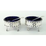 PAIR OF MATCHED 18TH CENTURY SILVER PIERCED AND ENGRAVED OVAL SALTS, each raised on four ball and