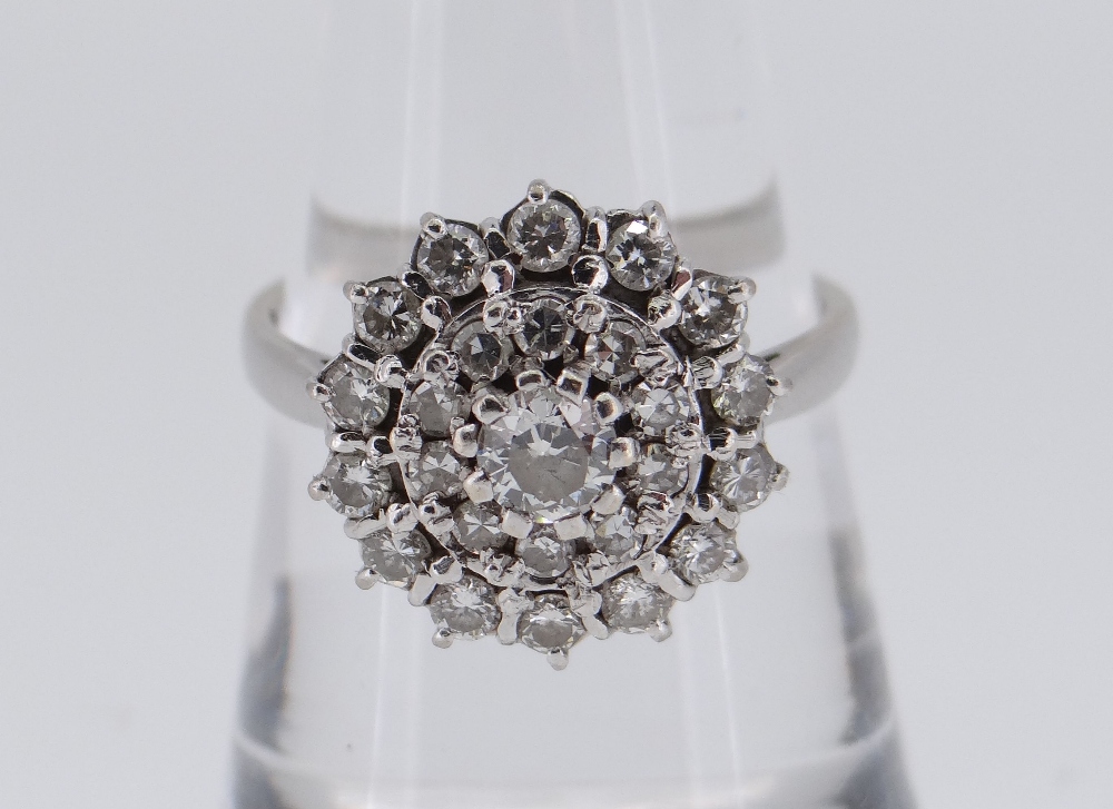 18CT WHITE GOLD DIAMOND CLUSTER RING, the central stone weighing approximately 0.2cts and surrounded