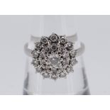 18CT WHITE GOLD DIAMOND CLUSTER RING, the central stone weighing approximately 0.2cts and surrounded