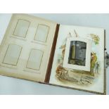 VICTORIAN LEATHER BOUND MUSICAL PHOTOGRAPH ALBUM containing small cylinder music box