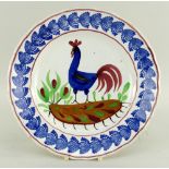 A LLANELLY COCKEREL PLATE typically decorated with sponged leaves to the border, believed to have