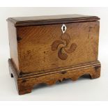 WELSH JOINED OAK MINIATURE COFFER having a stepped base with carved apron and bracket feet,