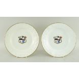 PAIR OF SWANSEA PORCELAIN PLATES having moulded floral borders, gilt rims and centred painted and