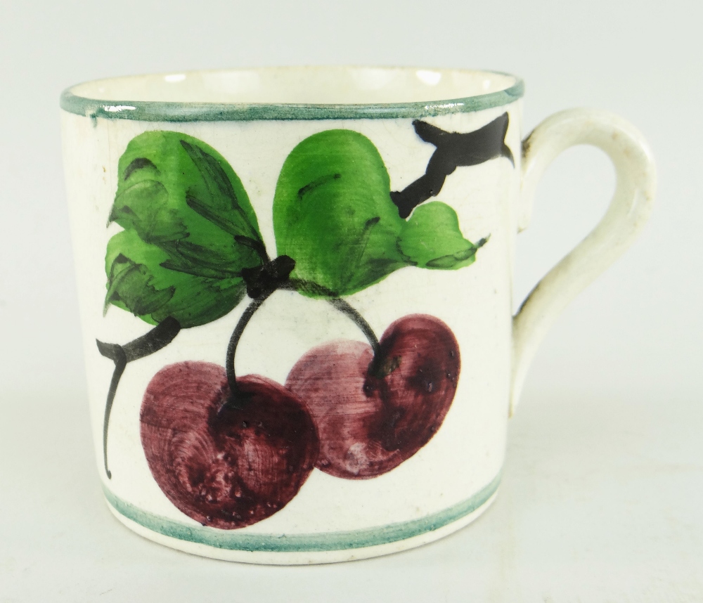SMALL LLANELLY POTTERY MUG PAINTED WITH PLUMS on a branch, stencilled Llanelly to base, 7cms high