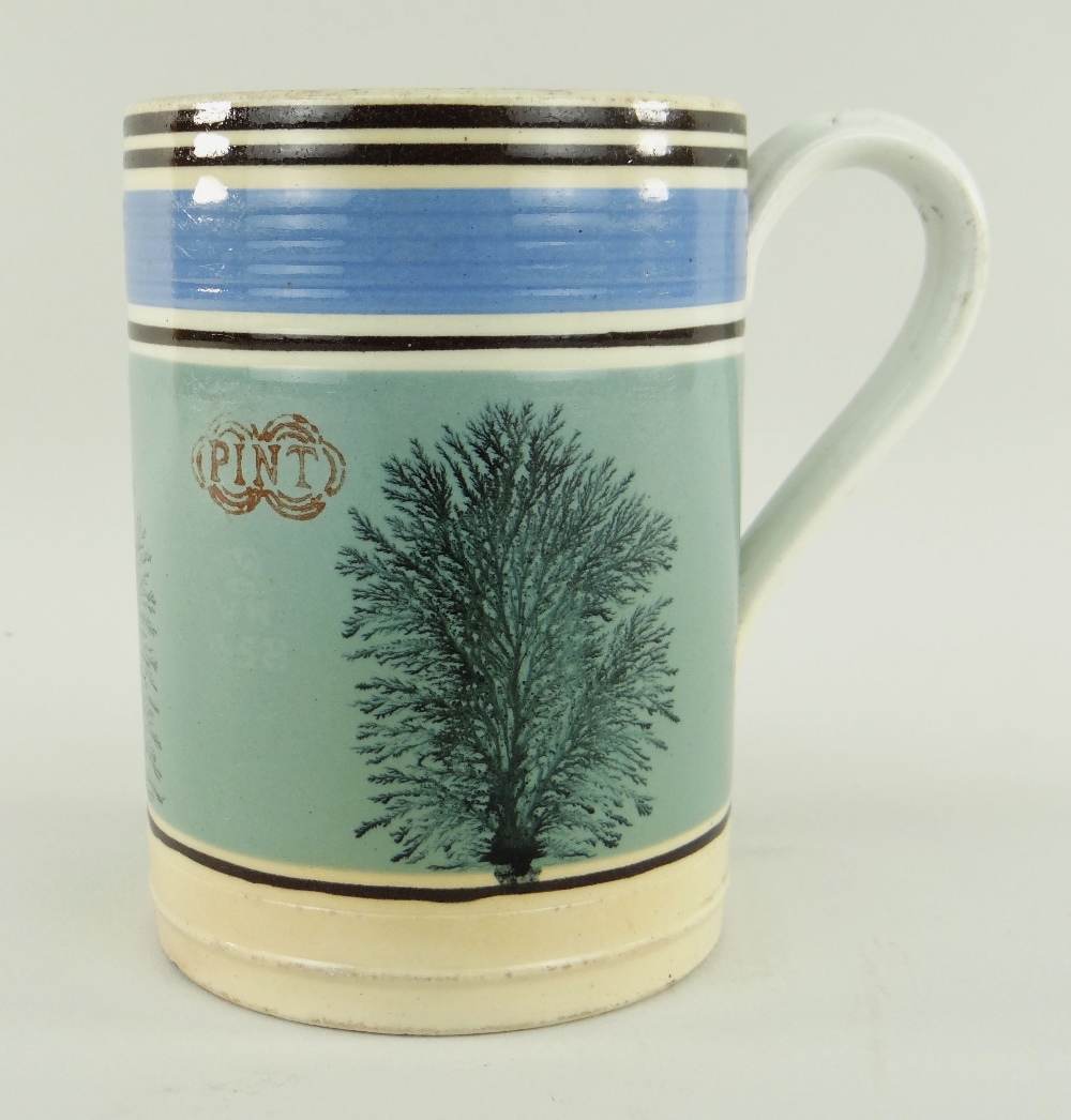 A LLANELLY POTTERY MOCHA WARE MEASURED PINT TANKARD decorated with sponged trees to coloured