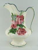 LLANELLY POTTERY TOILET JUG painted with roses, bellied and fluted body over a circular lobed foot