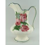 LLANELLY POTTERY TOILET JUG painted with roses, bellied and fluted body over a circular lobed foot