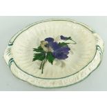 RARE LLANELLY POTTERY BREAD PLATE painted with pansies, the interior of fluted form, the sloped