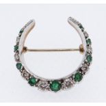 9CT GOLD EMERALD & DIAMOND CRESCENT BROOCH set with nine graduated emeralds and eight graduated