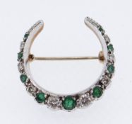 9CT GOLD EMERALD & DIAMOND CRESCENT BROOCH set with nine graduated emeralds and eight graduated