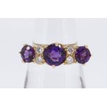 18CT GOLD SEVEN-STONE AMETHYST & DIAMOND RING, the three amethysts separated by four small