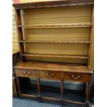 EARLY 19TH CENTURY WELSH OAK HIGH DRESSER with open three-shelf delft rack above base fitted three