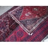 ASSORTED TRIBAL RUGS including a Shiraz, an Afghan Kafkazi and a Turkmen Ersari main rug, largest