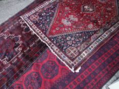 ASSORTED TRIBAL RUGS including a Shiraz, an Afghan Kafkazi and a Turkmen Ersari main rug, largest