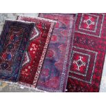 ASSORTED TRIBAL ENTRANCE OR SAMPLER RUGS including a Mashadi Baluch and Nishapur rugs (4)