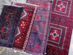 ASSORTED TRIBAL ENTRANCE OR SAMPLER RUGS including a Mashadi Baluch and Nishapur rugs (4)