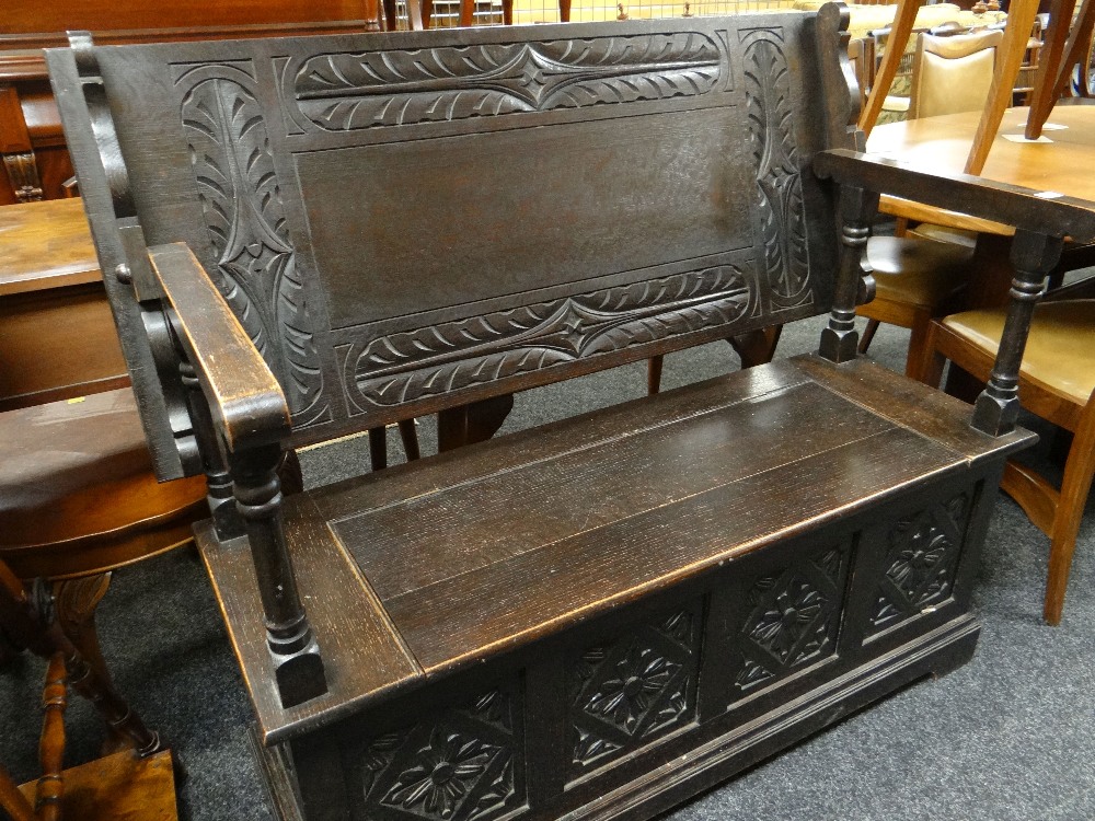 17TH CENTURY-STYLE CARVED OAK MONKS BENCH carved top and hinged box base, 122cms wide