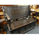 17TH CENTURY-STYLE CARVED OAK MONKS BENCH carved top and hinged box base, 122cms wide