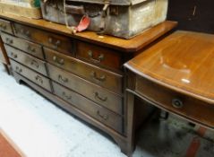 REPRODUCTION GEORGIAN-STYLE MAHOGANY CROSSBANDED NINE-DRAWER CHEST, 153cms wide and a reproduction