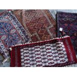 ASSORTED TRIBAL ENTRANCE OR SAMPLER RUGS including a Mashad narrow tent or pillow bag (4)