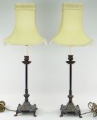 PAIR OF CAST METAL CANDLESTICK TABLE LAMPS with ivory silk shades, overall 74cms high (2)